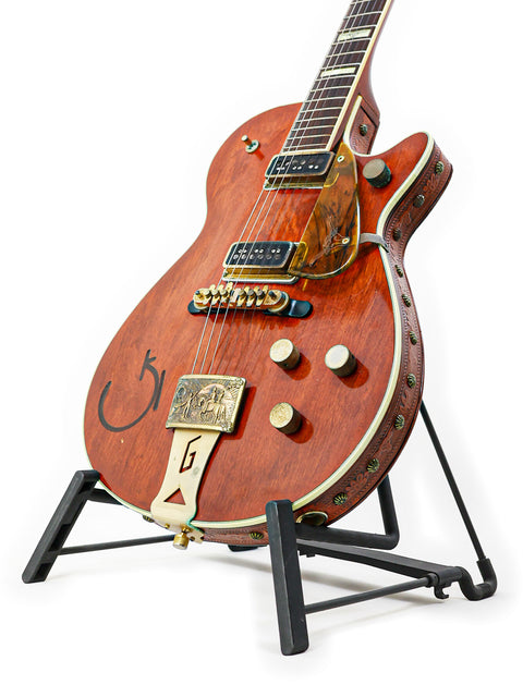 1955 Gretsch 6130 Roundup guitar resting on a stand, featuring a beautifully crafted wooden body.