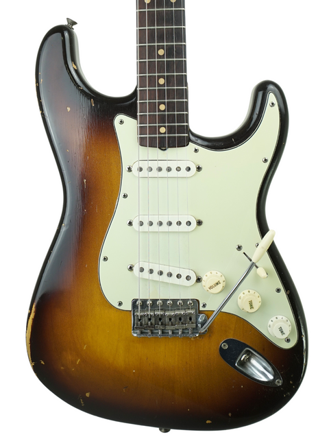 1959 Fender Custom Shop Stratocaster in a beautiful sunburst, resting in its original case, a true vintage gem for collectors.
