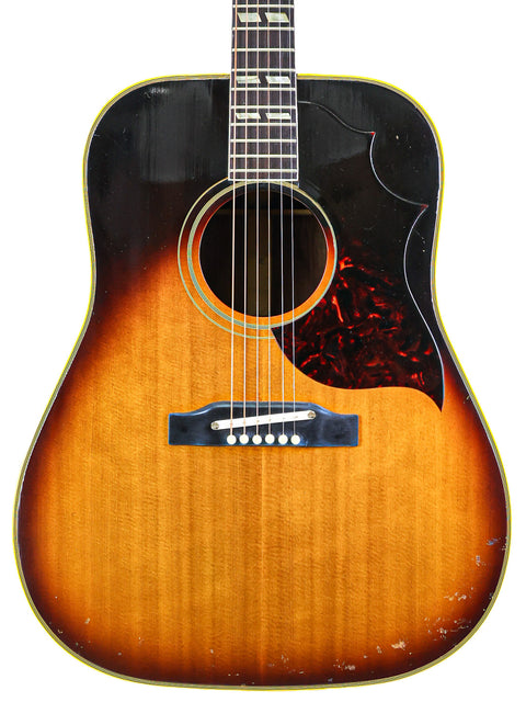 1964 Gibson Southern Jumbo acoustic guitar with a beautiful sunburst finish, showcasing vintage craftsmanship.