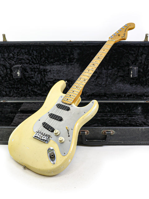 1974 Fender Stratocaster guitar in a case, elegantly showcased against a simple white background.