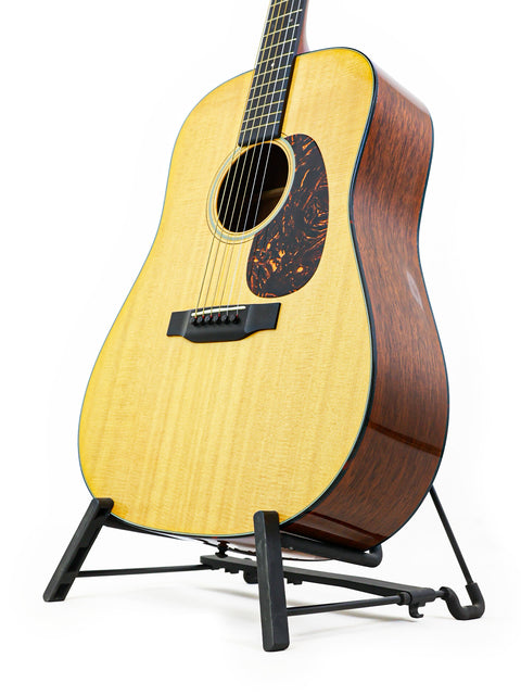 2012 Martin D-18 guitar resting on a stand, set against a bright white background, highlighting its craftsmanship.