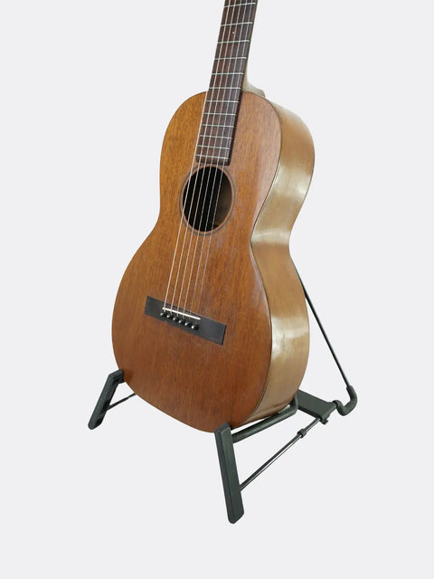 Acoustic Martin 2-17 guitar on a stand against a white background
