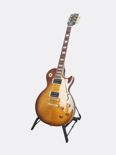1995 Gibson Jimmy Page Signature Les Paul guitar on a stand against a white background