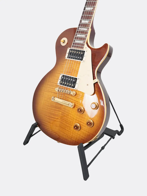 1995 Gibson Jimmy Page Signature Les Paul guitar on a stand against a light gray background