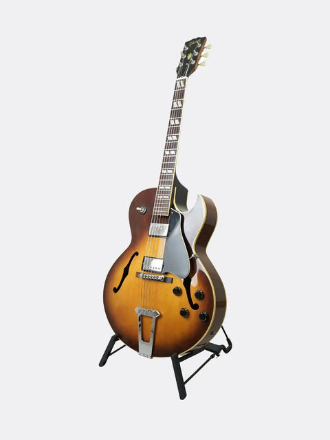 Gibson ES-175 guitar on a stand against a white background