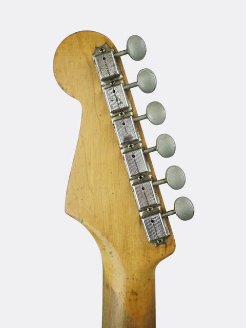 Fender Stratocaster headstock with tuning pegs on a white background