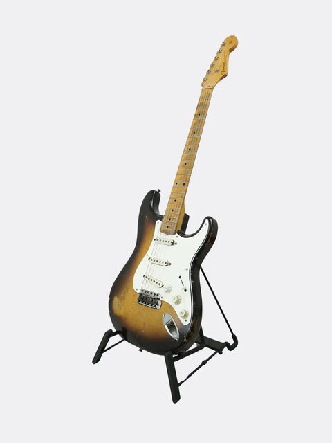 Fender Stratocaster guitar on a stand against a white background