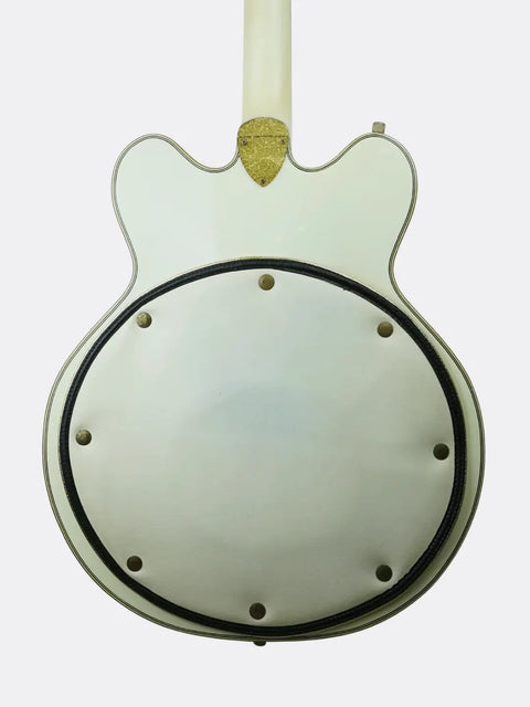 Close-up of a 1972 Gretsch White Falcon resonator with gold center on a light gray background