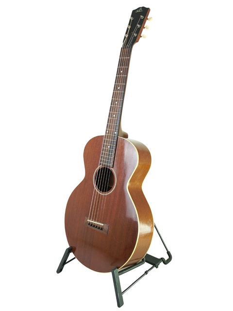 A 1929 vintage Gibson L-0 guitar resting on a stand, highlighting its historical significance and timeless beauty.