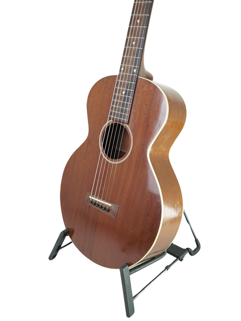 A 1929 vintage Gibson L-0 guitar resting on a stand, highlighting its timeless beauty and historical significance.
