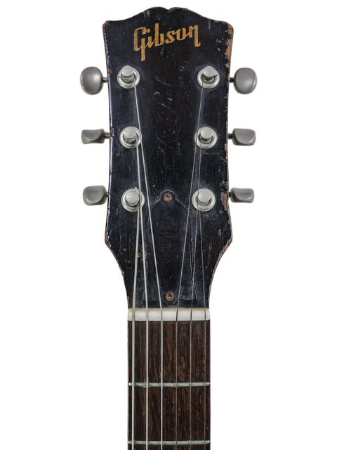 A 1953 Gibson Les Paul Custom guitar, featuring a vintage yellow refinishing, exemplifying classic American craftsmanship.