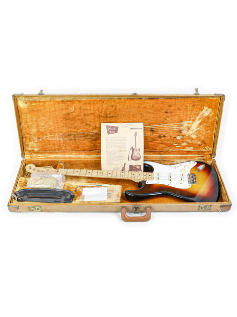 A 1958 Fender Stratocaster guitar securely housed in a wooden case, capturing the essence of vintage music history.