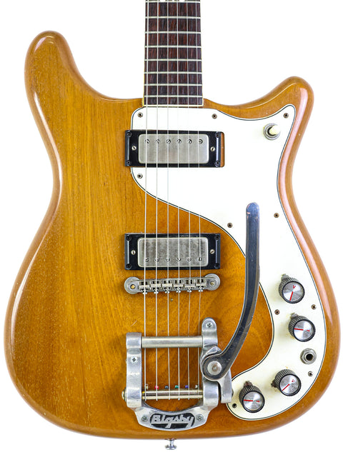 A 1964 Epiphone Crestwood Custom guitar featuring a wooden body and a stylish white pickguard.