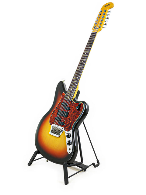 A 1966 Fender Electric XII guitar elegantly resting on a stand, contrasted by a crisp white background for a vintage vibe.