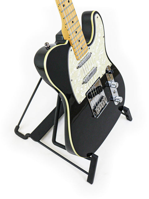 A 1999 black Fender Tele Plus V2 guitar elegantly resting on a stand, set against a white background.