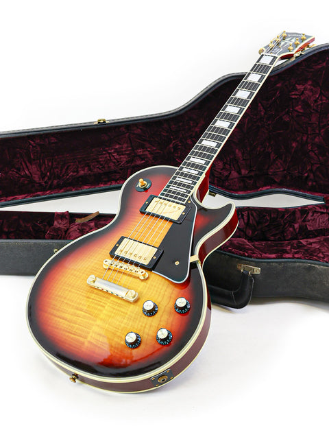 A 2006 Gibson Custom Shop '68 Reissue Les Paul Custom guitar displayed with its protective case, highlighting its elegance.