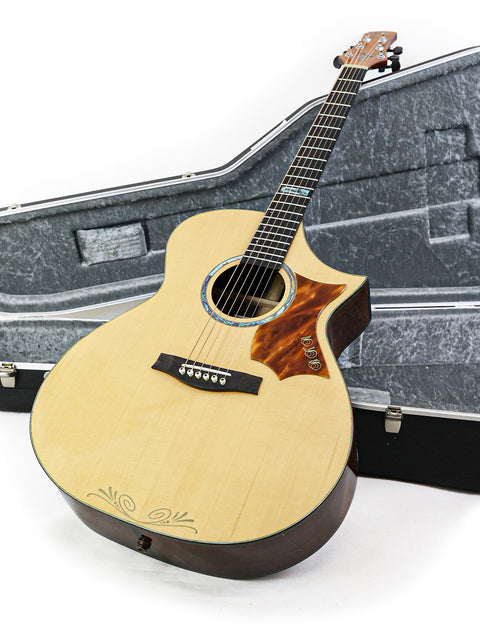 A 2015 James Cargill Custom guitar is nestled in its case, set against a stark white background, highlighting its craftsmanship.