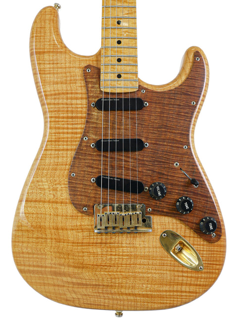 A Fender Custom Shop 'Clapton' Stratocaster guitar with a wooden body and neck, crafted in the USA in 1992.