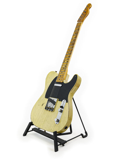 A Fender Nocaster guitar from the Custom Shop, elegantly positioned on a stand with a white background.
