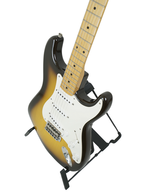 A Fender Paul Waller Masterbuilt '56 Stratocaster on a black stand, featuring a minimalist white background for visual contrast.