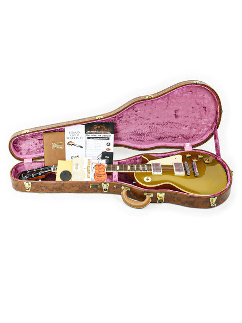 A Gibson Custom Shop LPR-7 1957 Les Paul Goldtop Reissue guitar nestled inside its case, showcasing its elegant design.