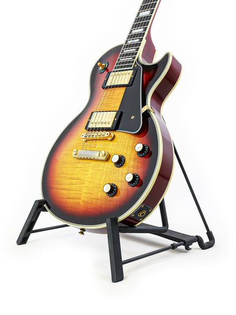 A Les Paul Custom guitar from Gibson's 2006 '68 Reissue series, elegantly positioned on a stand with a white background.