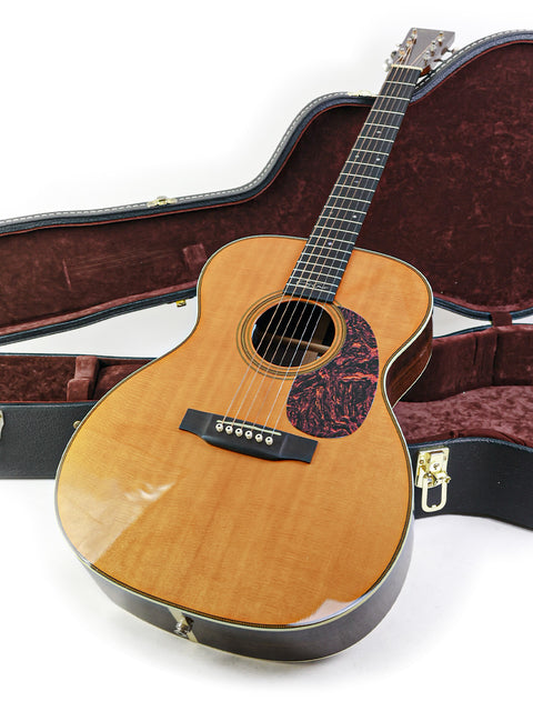 A Martin 000-28EC Eric Clapton Signature guitar resting in its case, showcasing its elegant design and craftsmanship.