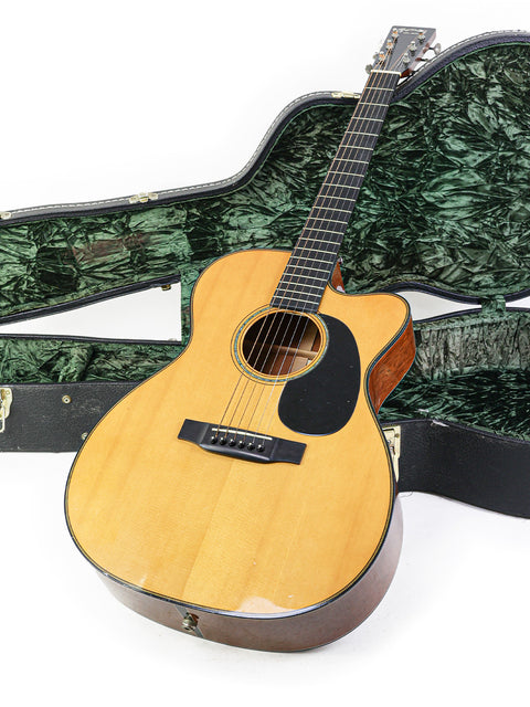 A Martin 000-C David Gray Custom guitar in its case, displayed on a clean white background, showcasing its unique design.