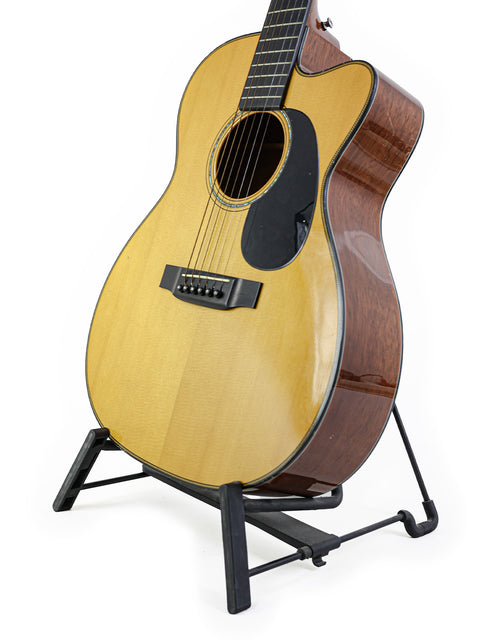 A Martin 000-C David Gray Custom guitar, prototype #1 of 4, displayed on a stand with a simple white backdrop.