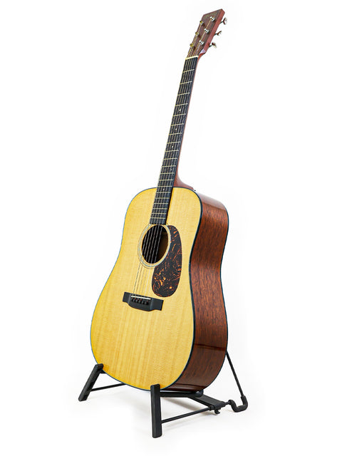 A Martin D-18 guitar from 2012 displayed on a stand, set against a clean white background.