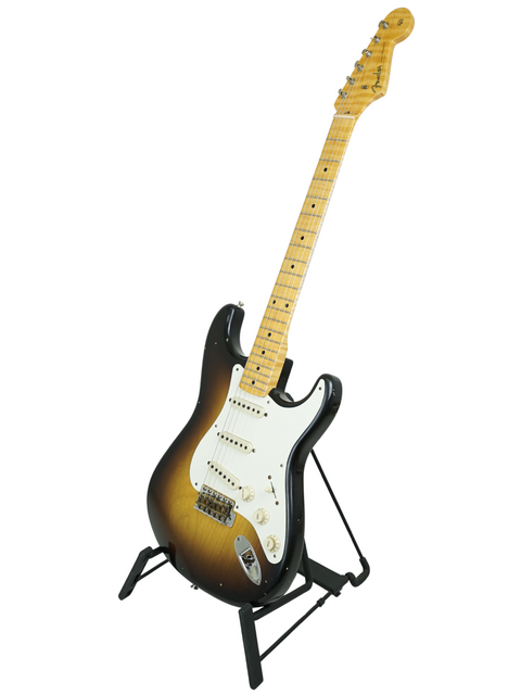 A Masterbuilt '57 Stratocaster by Fender on a stand, set against a simple white background.