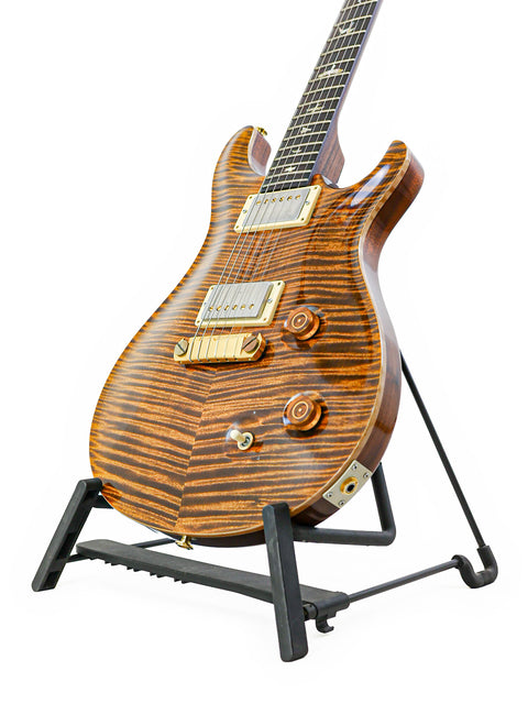 A PRS Modern Eagle 1 guitar from 2007 displayed on a stand with a sleek black base.