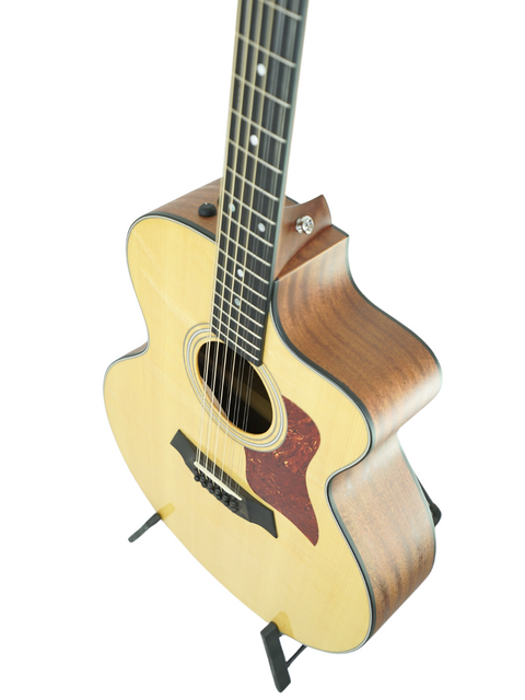 A Taylor 355ce 12-string acoustic guitar from 2011 elegantly positioned on a stand, perfect for music lovers.
