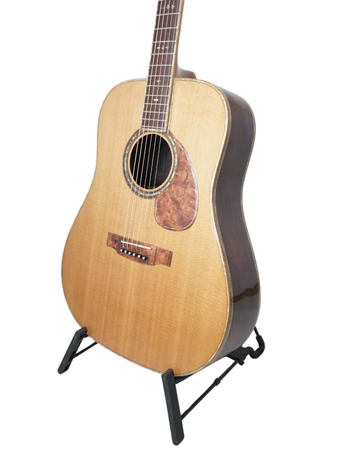 A beautifully crafted Philson Custom D-18 Style Cocobolo guitar displayed on a stand, with a stark white backdrop highlighting its features.