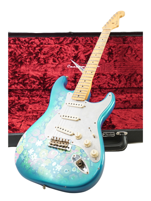 A blue Fender Custom Shop EL Diablo Strat guitar featuring a vibrant floral design, showcasing its unique artistry.