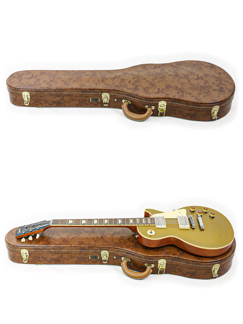 A case containing two guitars, showcasing a gold-finished Gibson Custom Shop LPR-7 1957 Les Paul Goldtop Reissue, USA 2019.