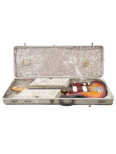 A classic 1962 USA Fender Jazzmaster guitar inside a case, with a plain white background highlighting its features.