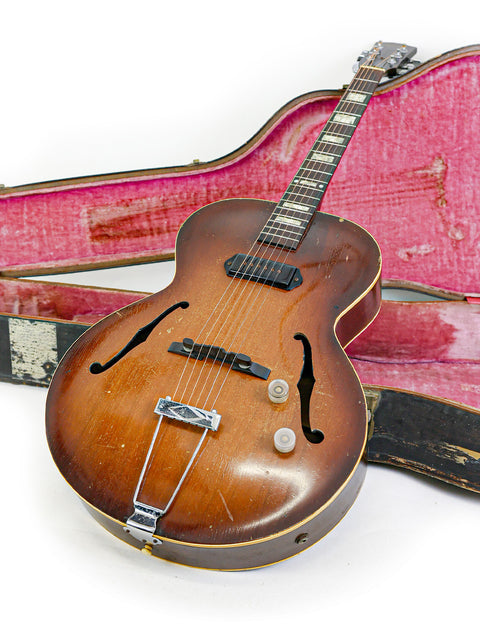 A classic brown Gibson ES-125 guitar, made in the USA between 1948-52, displayed in its case on a pristine white background.