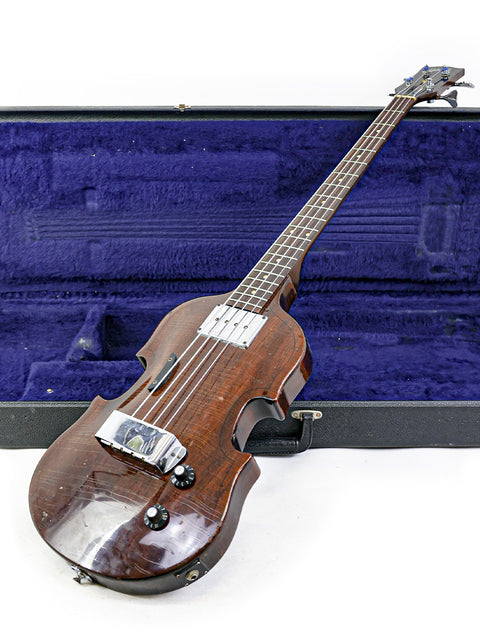 A classic brown electric bass guitar, the 1969 Gibson EB-1, resting in its case, highlighting its vintage appeal.