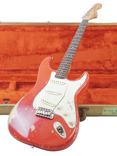 A classic red Fender Stratocaster from 1979, securely placed in a wooden case, exuding vintage elegance.