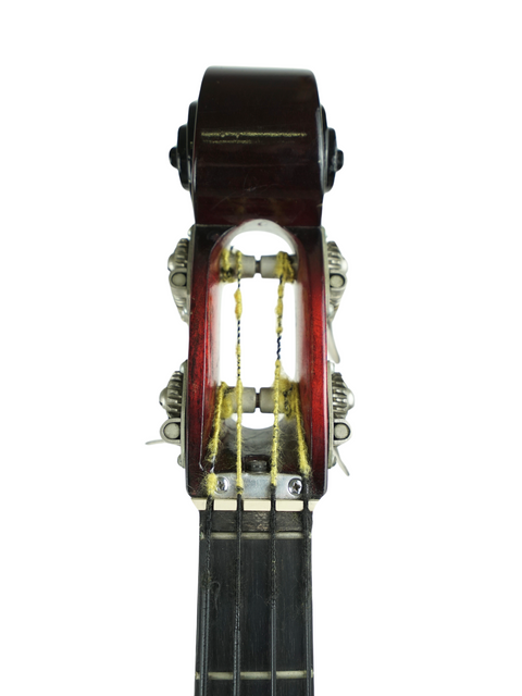 A close-up of a 1966 Ampeg AEB-1 electric bass guitar, focusing on the string attached to the instrument.