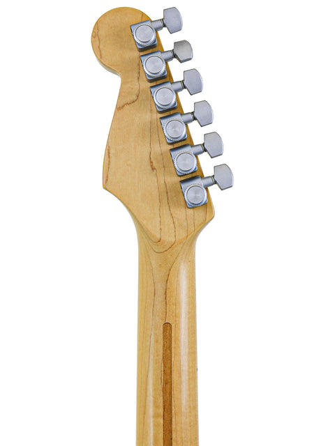 A close-up of a Fender Strat Plus Deluxe guitar head, featuring a wooden body and a metal bridge, USA 1993 model.