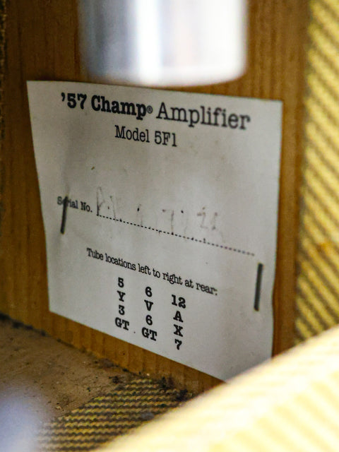 A label on a wooden box displaying "Champ Amplifier" from the Fender Custom Shop '57 Champ Combo, USA, 2009.