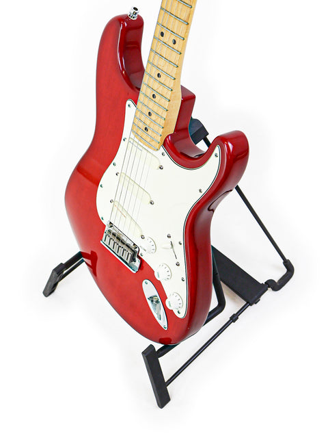 A red 1993 Fender Strat Plus Deluxe guitar displayed on a stand, highlighting its classic design and striking appearance.