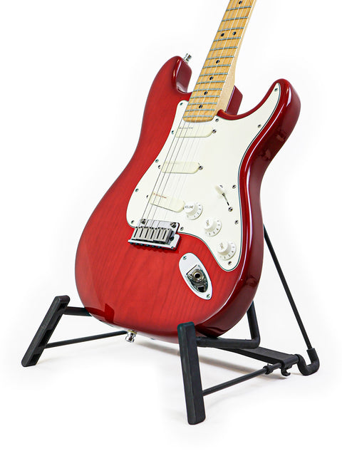 A red Fender Strat Plus Deluxe guitar from 1993 displayed on a stand against a clean white background.
