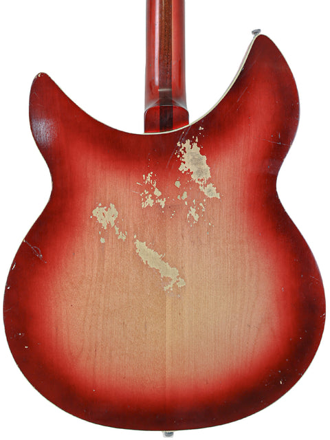 A red Rickenbacker 12-string guitar from 1965, presented against a white backdrop, showcasing its vintage appeal.