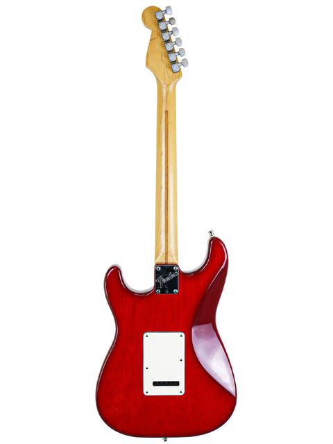 A red electric guitar with a white body, specifically a Fender Strat Plus Deluxe from the USA, model year 1993.