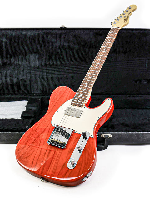 A red electric guitar within a case, representing the G&L Fullerton Deluxe ASAT Classic Bluesboy, made in the USA, 2018.