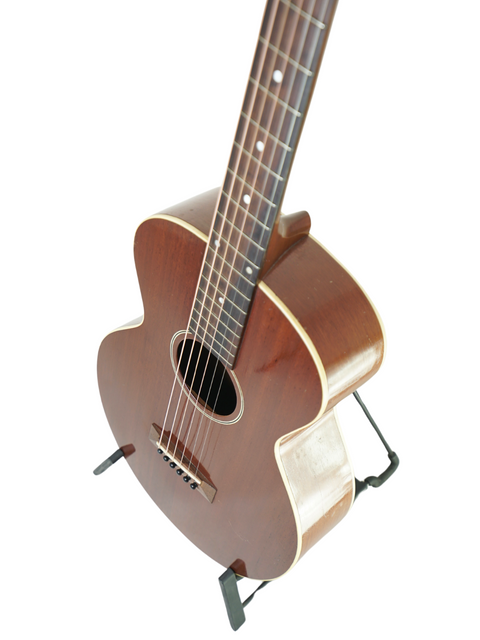 A small vintage Gibson L-0 acoustic guitar from 1929, elegantly positioned on a stand, highlighting its historical significance.