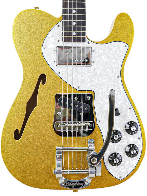 A stunning gold guitar with a white pickguard, showcasing the Txxx Custom Thinline '72 Partscaster with B5 Bigsby from 2022.